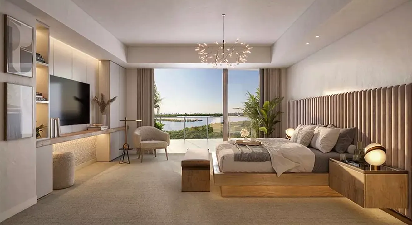 Primary bedroom with chandelier and water view